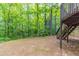 Backyard features a lush treeline and a deck with wooden stairs, perfect for outdoor relaxation at 6416 Vicksburg Nw Ct, Acworth, GA 30101