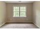 Bright bedroom with double windows overlooking lush greenery, neutral walls, and cozy carpet at 6416 Vicksburg Nw Ct, Acworth, GA 30101