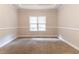 Bedroom featuring neutral carpet, tray ceiling, and double windows with natural light at 6416 Vicksburg Nw Ct, Acworth, GA 30101
