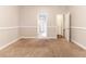Empty bedroom with neutral carpet and white trim at 6416 Vicksburg Nw Ct, Acworth, GA 30101