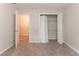 Bedroom featuring plush carpet, an open door to another room, and a closet with bi-fold doors at 6416 Vicksburg Nw Ct, Acworth, GA 30101