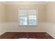 Dining room with hardwood floors, wainscoting, and a window with blinds at 6416 Vicksburg Nw Ct, Acworth, GA 30101