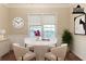 Dining room with round table, white chairs, and a window with blinds at 6416 Vicksburg Nw Ct, Acworth, GA 30101