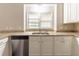 Kitchen with stainless steel dishwasher, white cabinets, granite countertops, and window view at 6416 Vicksburg Nw Ct, Acworth, GA 30101