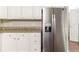 Kitchen featuring stainless steel refrigerator, granite countertops, and white cabinets at 6416 Vicksburg Nw Ct, Acworth, GA 30101