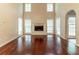 Bright living room with hardwood floors, fireplace, and large windows for natural light at 6416 Vicksburg Nw Ct, Acworth, GA 30101