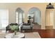 Bright living room with arched doorways leading to the dining room and kitchen at 6416 Vicksburg Nw Ct, Acworth, GA 30101