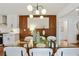 Elegant dining room featuring a glass table, stylish lighting, and an open floor plan to the kitchen at 1221 Oakfield Se Dr, Atlanta, GA 30316