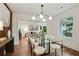 Open-concept dining area with modern light fixture and hardwood floors, flowing into the living room at 1221 Oakfield Se Dr, Atlanta, GA 30316