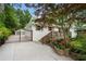 Charming home with a gated driveway, manicured lawn, and lovely landscaping at 1221 Oakfield Se Dr, Atlanta, GA 30316