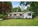 Charming single-story white brick home with a manicured lawn and beautiful landscaping at 1221 Oakfield Se Dr, Atlanta, GA 30316