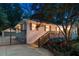Well-lit home exterior with modern white brick, deck, manicured lawn, and automated gate access at 1221 Oakfield Se Dr, Atlanta, GA 30316