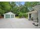 Exterior view of a house featuring a spacious driveway and detached garage at 1221 Oakfield Se Dr, Atlanta, GA 30316