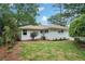 Charming white brick home exterior with a well-maintained lawn and manicured landscaping at 1221 Oakfield Se Dr, Atlanta, GA 30316