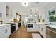 Open kitchen featuring white cabinets, stainless steel appliances, and hardwood floors at 1221 Oakfield Se Dr, Atlanta, GA 30316