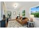 Cozy living room with a leather sofa, natural light, and stylish decor at 1221 Oakfield Se Dr, Atlanta, GA 30316