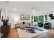 Bright living room featuring hardwood floors, neutral decor, and large windows with a lush view at 1221 Oakfield Se Dr, Atlanta, GA 30316