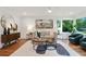 Bright living room featuring hardwood floors, neutral decor, and large windows with a lush view at 1221 Oakfield Se Dr, Atlanta, GA 30316