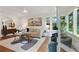 Bright living room featuring hardwood floors, neutral decor, and large windows with a lush view at 1221 Oakfield Se Dr, Atlanta, GA 30316
