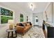 Comfortable living room featuring hardwood floors, modern decor, and plenty of natural light at 1221 Oakfield Se Dr, Atlanta, GA 30316