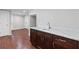 Basement bar area with granite countertop, custom wood cabinets and access to the utility room at 3341 Cranmore Chase, Marietta, GA 30066