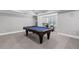 Finished basement with a billiard table and cozy seating area with natural light at 3341 Cranmore Chase, Marietta, GA 30066