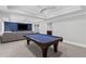 Finished basement area with a pool table and custom blue built-in cabinets at 3341 Cranmore Chase, Marietta, GA 30066