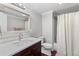 This bathroom features a dark wood vanity, quartz countertop, and a shower with a curtain at 3341 Cranmore Chase, Marietta, GA 30066
