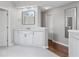Well-lit bathroom boasts a large vanity with quartz countertops, a modern mirror, and hardwood floors at 3341 Cranmore Chase, Marietta, GA 30066