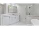 Stylish bathroom featuring vanity with quartz counters, glass shower, soaking tub, and modern mirror at 3341 Cranmore Chase, Marietta, GA 30066