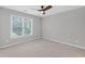 Neutral bedroom with a ceiling fan and natural light, featuring a large window at 3341 Cranmore Chase, Marietta, GA 30066