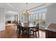 Elegant dining room features hardwood floors, large window with shutters and stylish chandelier at 3341 Cranmore Chase, Marietta, GA 30066