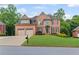 Beautiful brick two-story home featuring a well-manicured front lawn and a two-car garage at 3341 Cranmore Chase, Marietta, GA 30066