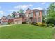 Charming brick two-story home with a lush green lawn and a convenient two-car garage at 3341 Cranmore Chase, Marietta, GA 30066