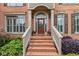 Elegant front entry featuring a brick staircase, decorative door, and manicured landscaping at 3341 Cranmore Chase, Marietta, GA 30066