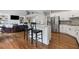 Modern kitchen with white cabinetry, stainless steel appliances, a breakfast bar, and hardwood floors at 3341 Cranmore Chase, Marietta, GA 30066
