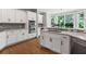 Modern kitchen featuring white cabinets, stainless steel appliances, and a breakfast nook with bright windows at 3341 Cranmore Chase, Marietta, GA 30066