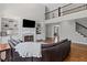 Bright living room features a fireplace with built-in bookshelves, a staircase, and a second floor balcony at 3341 Cranmore Chase, Marietta, GA 30066