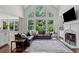Stunning living room with a large window, modern fireplace, hardwood floors, and leather furniture at 3341 Cranmore Chase, Marietta, GA 30066