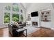 Inviting living room with a soaring window, fireplace, built-ins, and gleaming hardwood floors at 3341 Cranmore Chase, Marietta, GA 30066