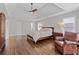 Bright main bedroom with seating, wood floors, a ceiling fan and tray ceiling at 3341 Cranmore Chase, Marietta, GA 30066