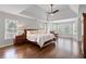 Spacious main bedroom with tray ceiling, a ceiling fan, hardwood floors and lots of light at 3341 Cranmore Chase, Marietta, GA 30066