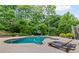 Backyard pool area with a hot tub, mature trees, and a lounge area at 3341 Cranmore Chase, Marietta, GA 30066