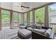 Relaxing sunroom features comfortable seating, outdoor views, and a ceiling fan at 3341 Cranmore Chase, Marietta, GA 30066