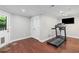 Basement workout area with a treadmill, wood floors, and access to the exterior at 3341 Cranmore Chase, Marietta, GA 30066