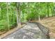Gravel driveway lined with mature trees offering a sense of privacy and seclusion at 3845 Parian Nw Rdg, Atlanta, GA 30327