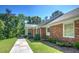 Well-maintained brick home featuring a sidewalk leading to the columned front porch at 3845 Parian Nw Rdg, Atlanta, GA 30327