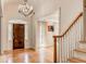 Elegant foyer with hardwood floors, chandelier, staircase, and a wooden front door at 3845 Parian Nw Rdg, Atlanta, GA 30327