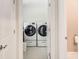Convenient laundry room with side-by-side washer and dryer and tile flooring at 3845 Parian Nw Rdg, Atlanta, GA 30327