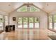 Bright living room featuring hardwood floors, a vaulted ceiling, many windows and a view of the pool at 3845 Parian Nw Rdg, Atlanta, GA 30327